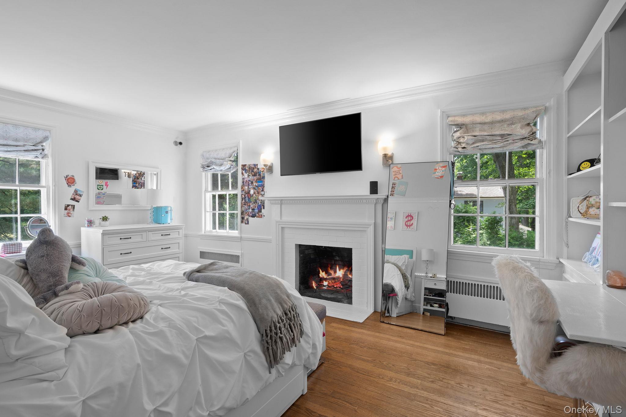 342 Woodbury Road Cold Spring Harbor, NY 11724 - Photo 17 of 29 a bedroom with a bed and a fireplace