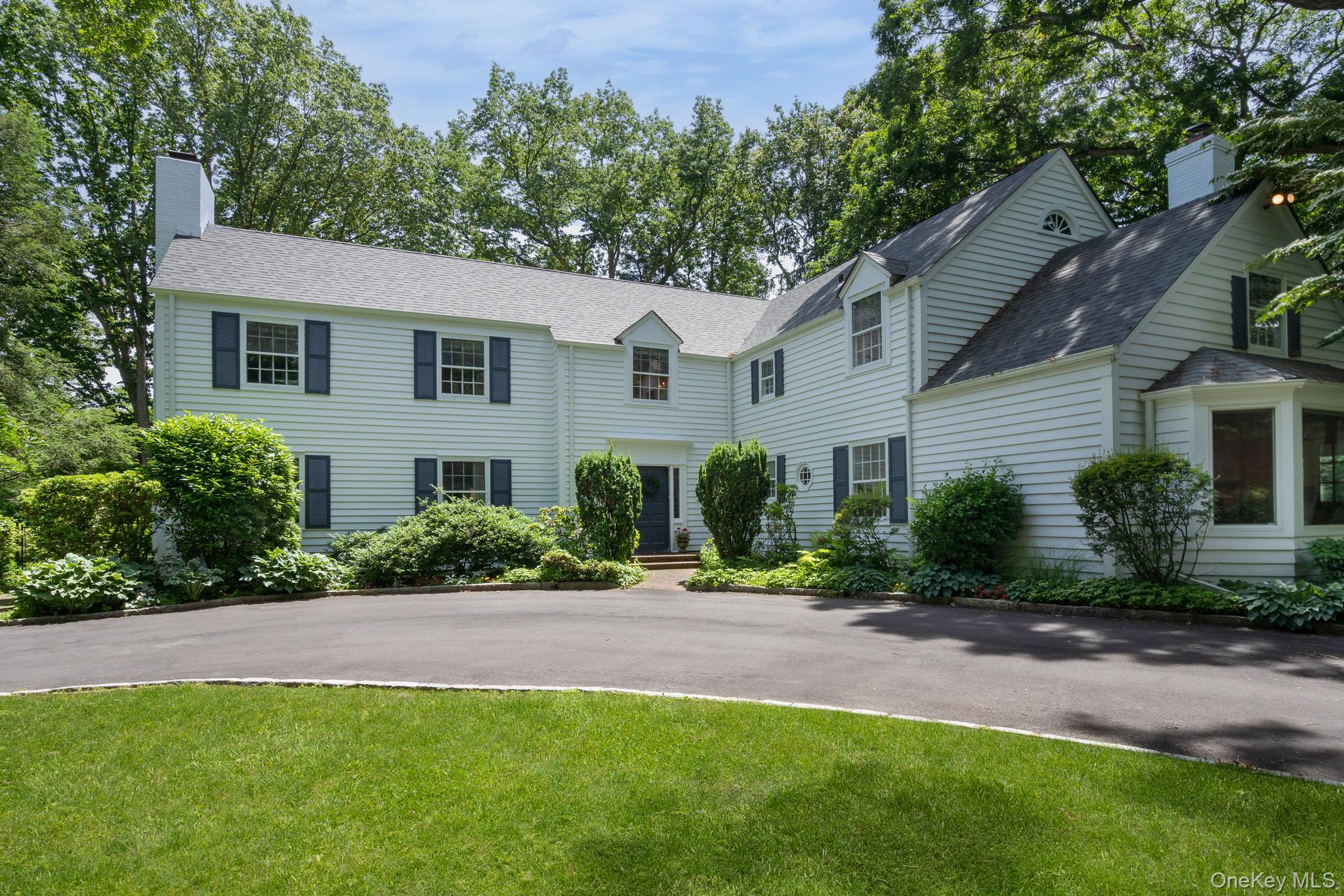 342 Woodbury Road Cold Spring Harbor, NY 11724 - Photo 2 of 29 a front view of a house with a yard and potted plants