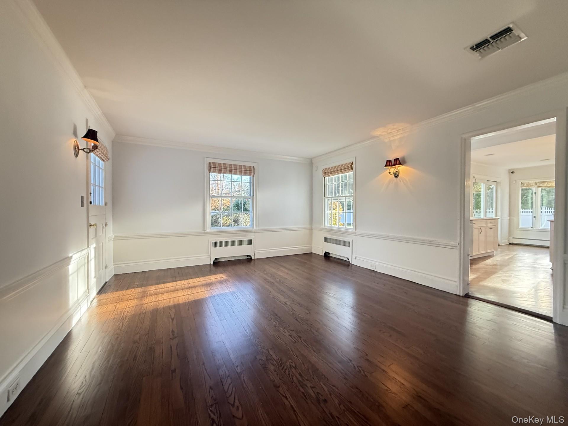 342 Woodbury Road Cold Spring Harbor, NY 11724 - Photo 8 of 29 an empty room with wooden floor and windows