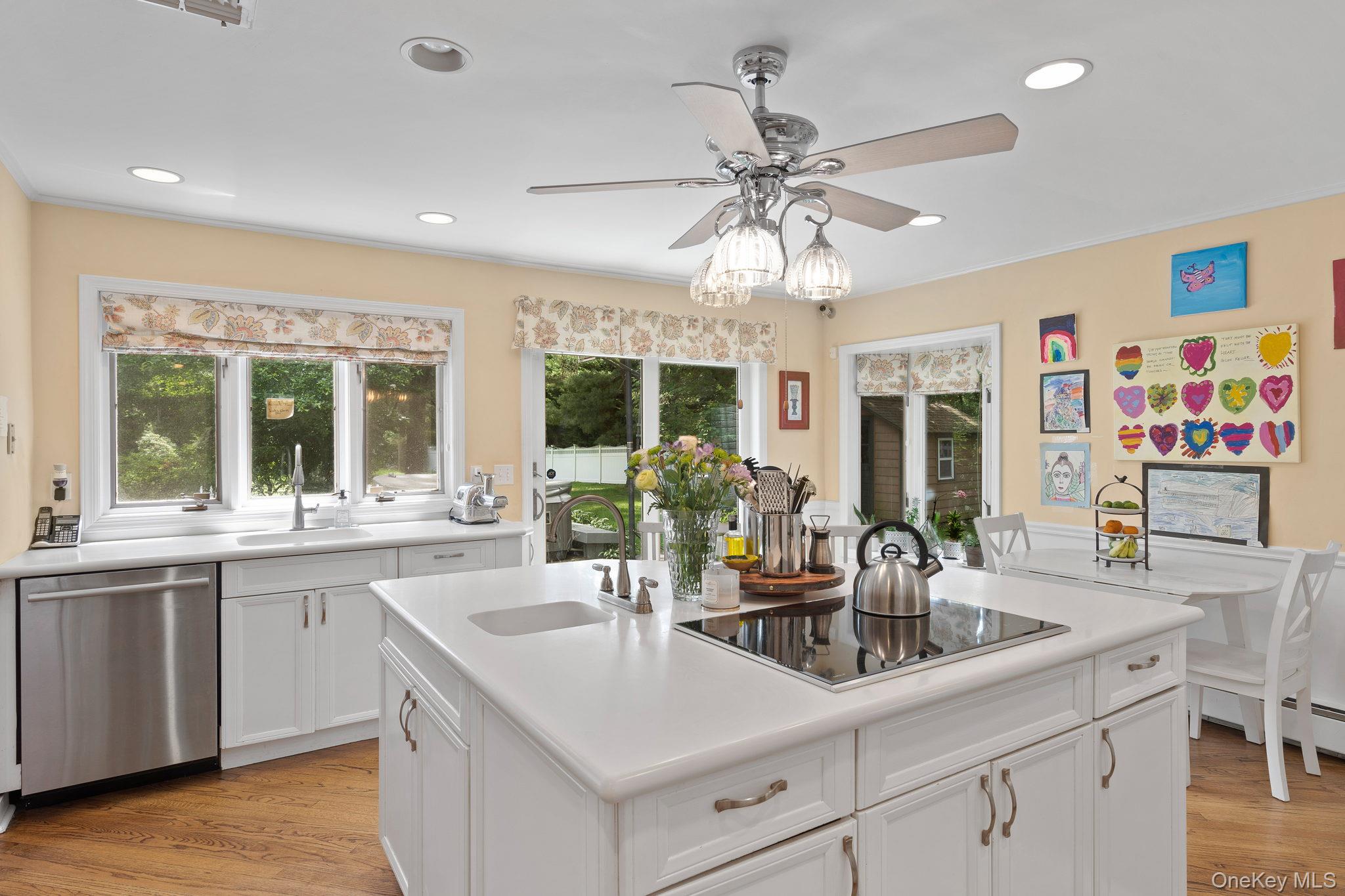 342 Woodbury Road Cold Spring Harbor, NY 11724 - Photo 10 of 29 a kitchen with stainless steel appliances a center island cabinets and wooden floor