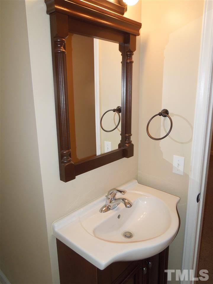 529 Maple Lane Raleigh, NC 27603 - Photo 14 of 21 a bathroom with a sink and a mirror