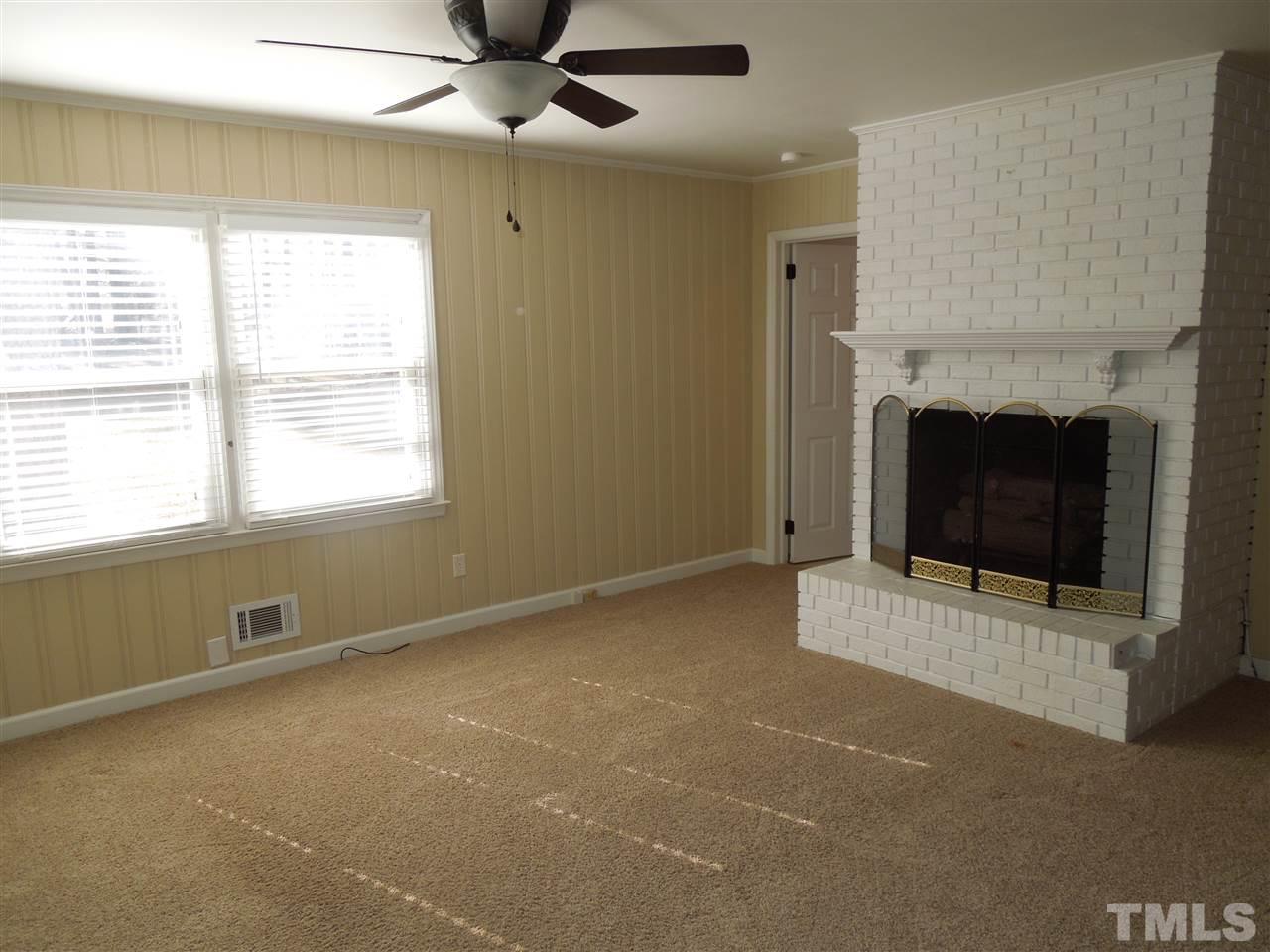 529 Maple Lane Raleigh, NC 27603 - Photo 9 of 21 a view of an empty room with a fireplace and a window