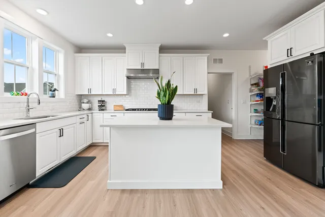 a kitchen with white cabinets and a stove