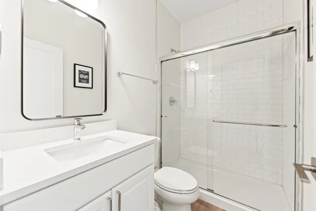 a bedroom with a bed a window and a flat screen television