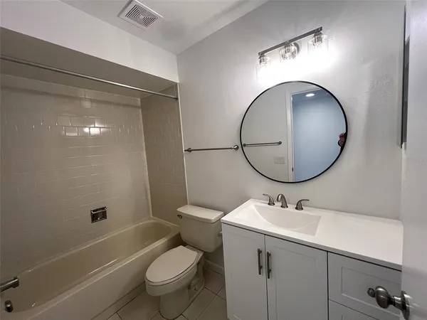 a bathroom with a sink mirror toilet and bathtub