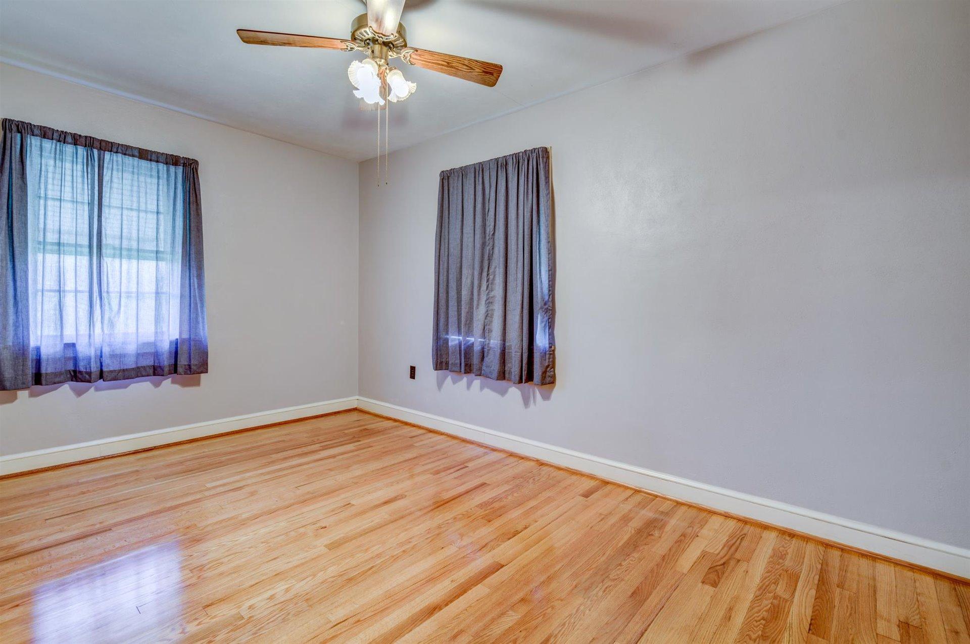 1054 Garner Road Vinton, VA 24179 - Photo 14 of 26 a view of an empty room with wooden floor and a window