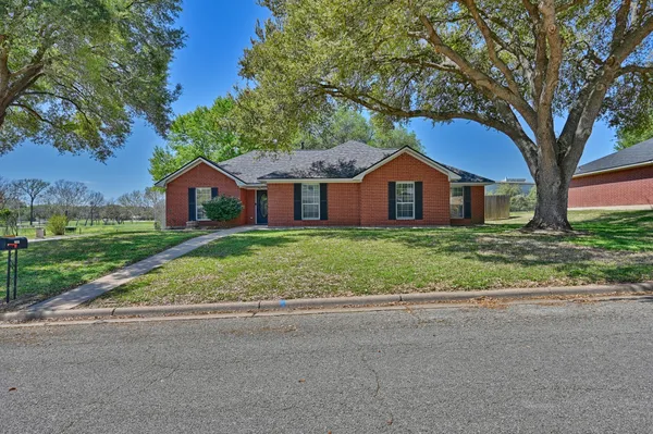 a front view of house with yard and green space