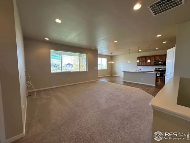 a kitchen with stainless steel appliances granite countertop a sink a stove and a refrigerator