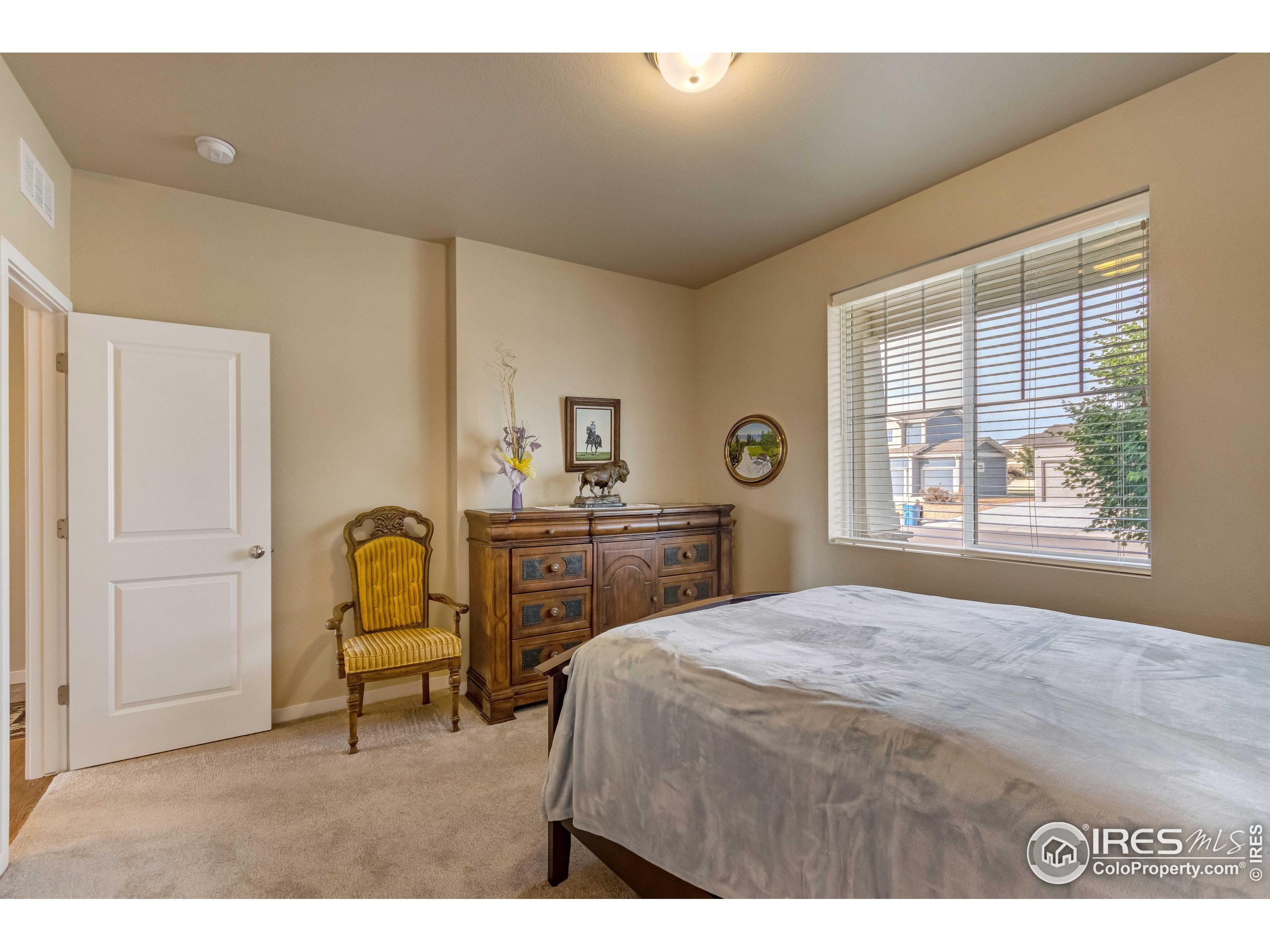 7213 Horsechestnut Street Wellington, CO 80549 - Photo 2 of 39 a bedroom with a bed and a window