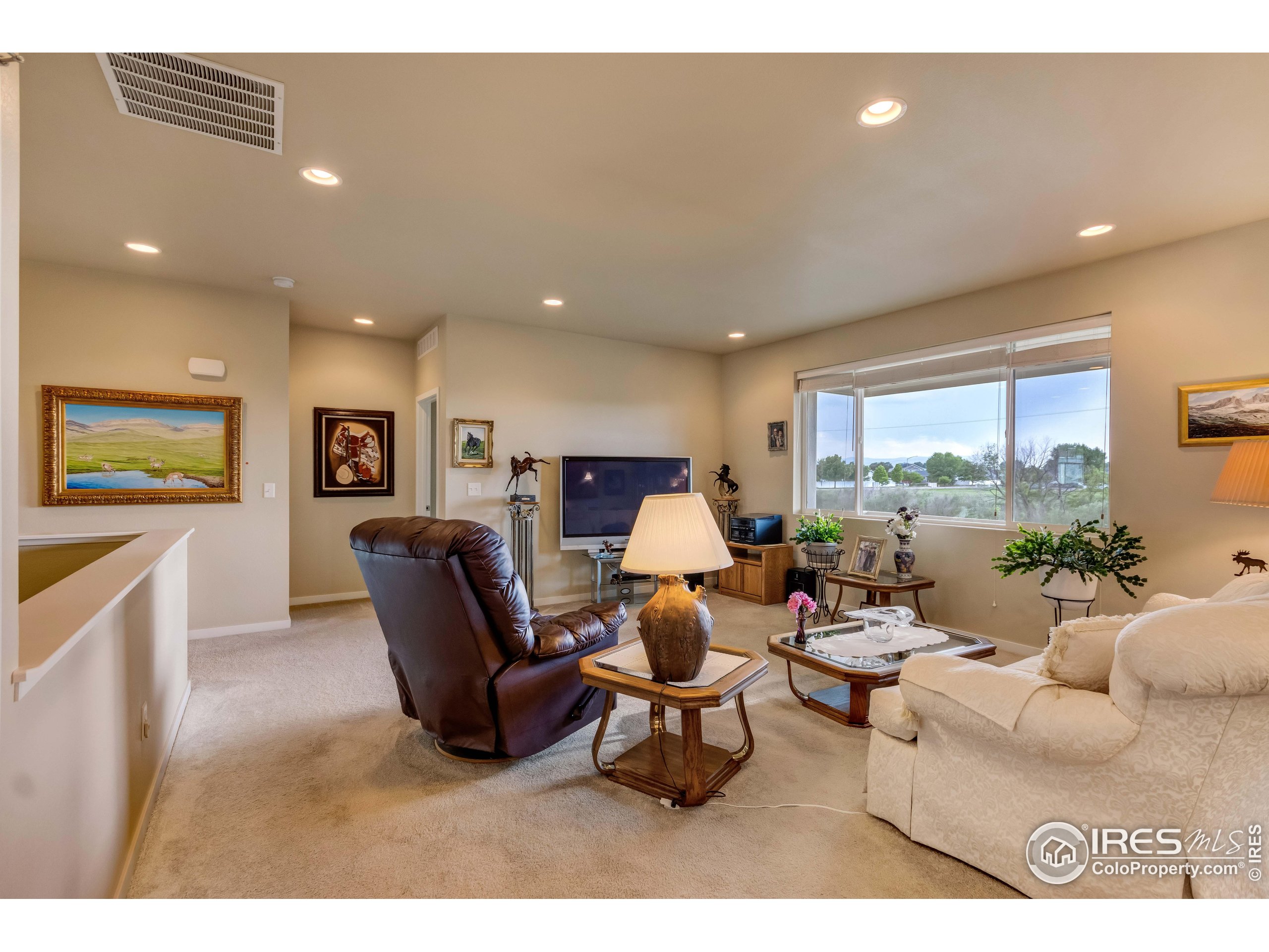 7213 Horsechestnut Street Wellington, CO 80549 - Photo 21 of 39 a living room with furniture and a large window