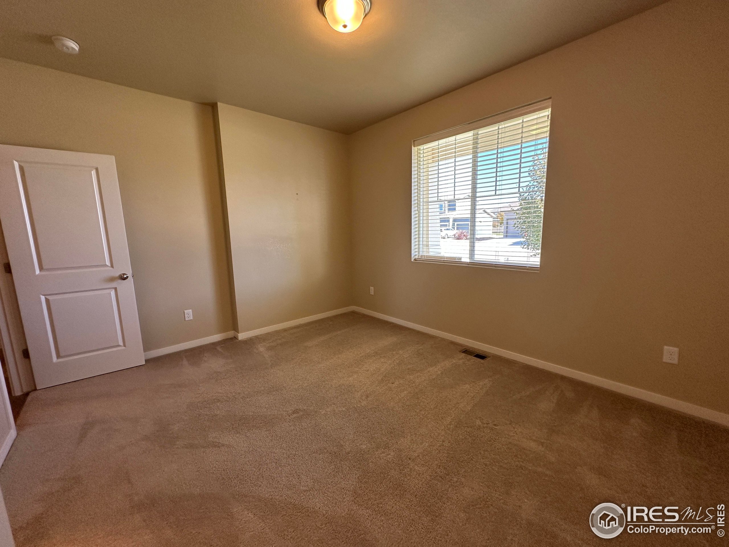 7213 Horsechestnut Street Wellington, CO 80549 - Photo 3 of 39 an empty room with windows