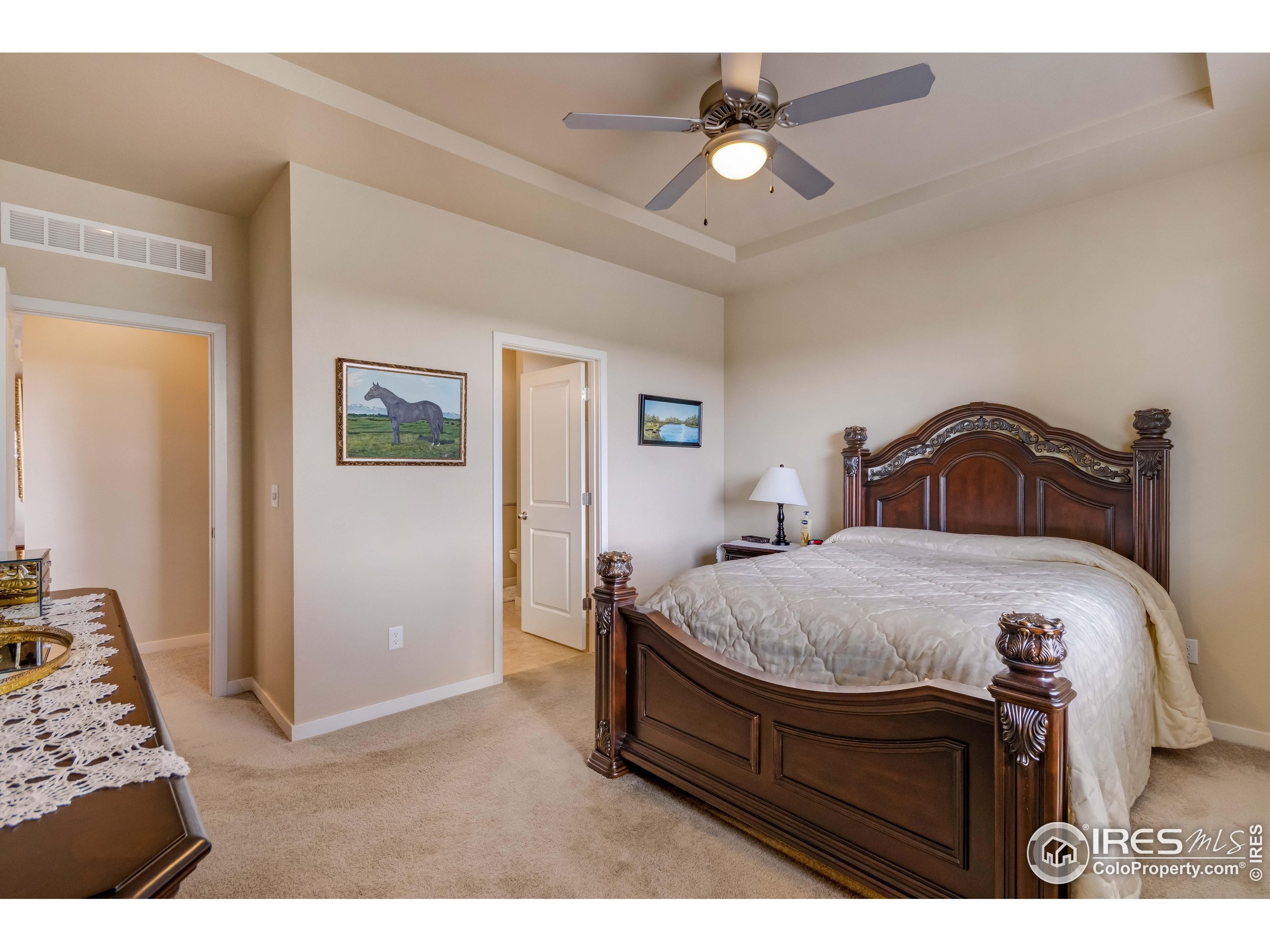 7213 Horsechestnut Street Wellington, CO 80549 - Photo 10 of 39 a bedroom with a bed and a chandelier