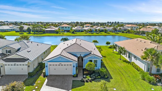 an aerial view of a house with a swimming pool yard and outdoor seating