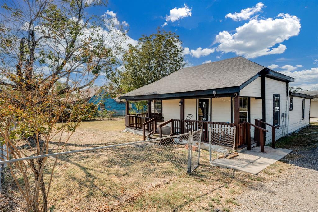 300 South Wall Street Itasca, TX 76055 - Photo 2 of 34 a view of a house with yard and sitting area