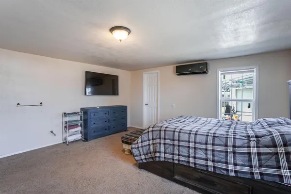 a bedroom with a bed and a flat screen tv
