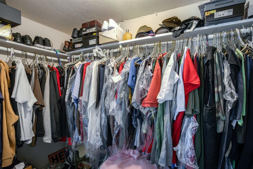 300 South Wall Street Itasca, TX 76055 - Photo 22 of 34 a view of walk in closet with clothes