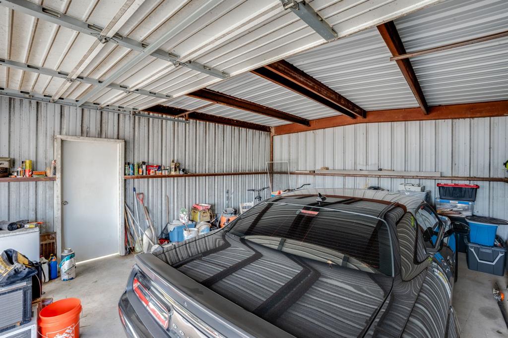 300 South Wall Street Itasca, TX 76055 - Photo 29 of 34 a bed sitting in a room next to a window