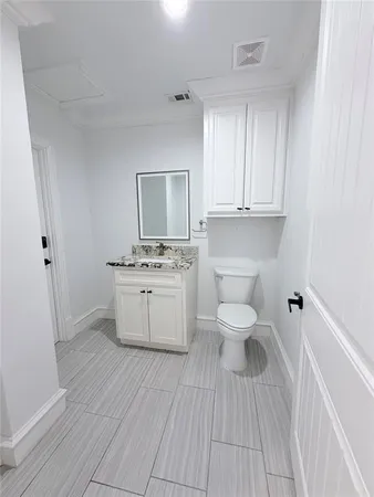 a bathroom with a sink toilet a mirror and vanity