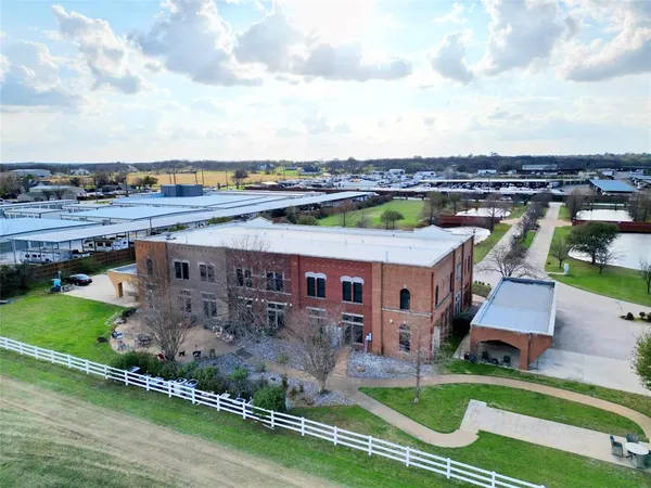 an aerial view of a house with a garden and lake view
