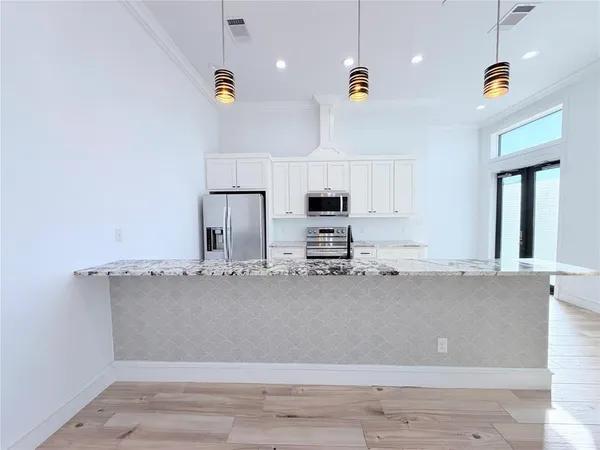 a view of kitchen with microwave and cabinets