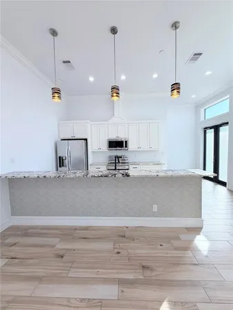 a view of a living room and kitchen