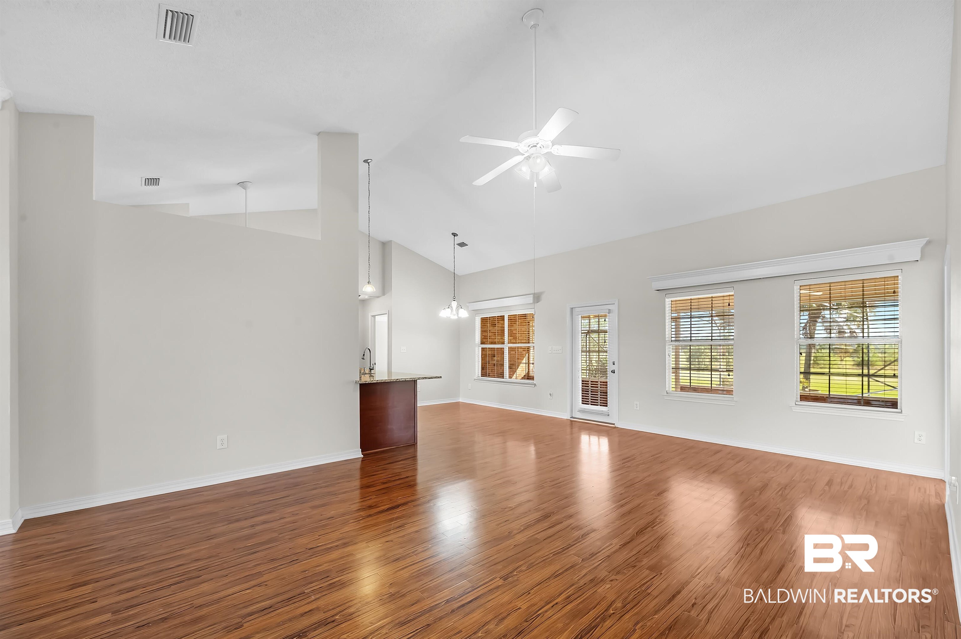 421 Collinwood Loop Foley, AL 36535 - Photo 20 of 62 Unfurnished living room featuring ceiling fan, hardwood / wood-style flooring, and high vaulted ceiling