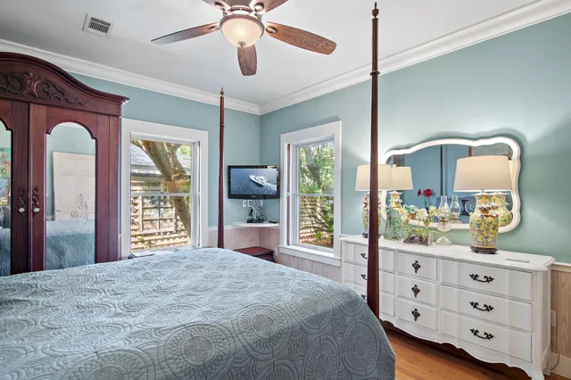 a bedroom with a bed and a dresser with mirror