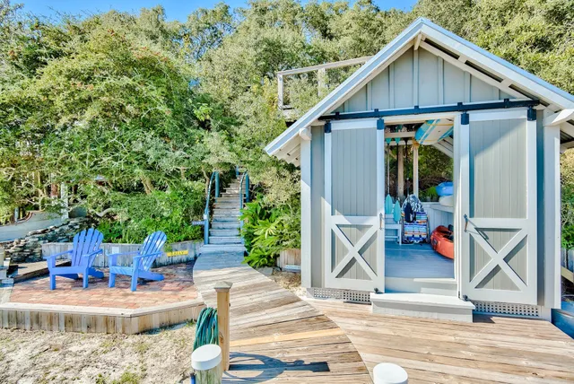 a view of small house along the path and trees