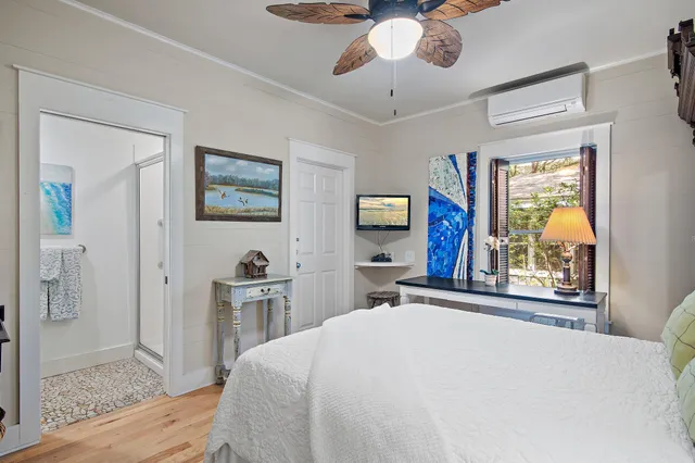 a bedroom with a bed and a chandelier