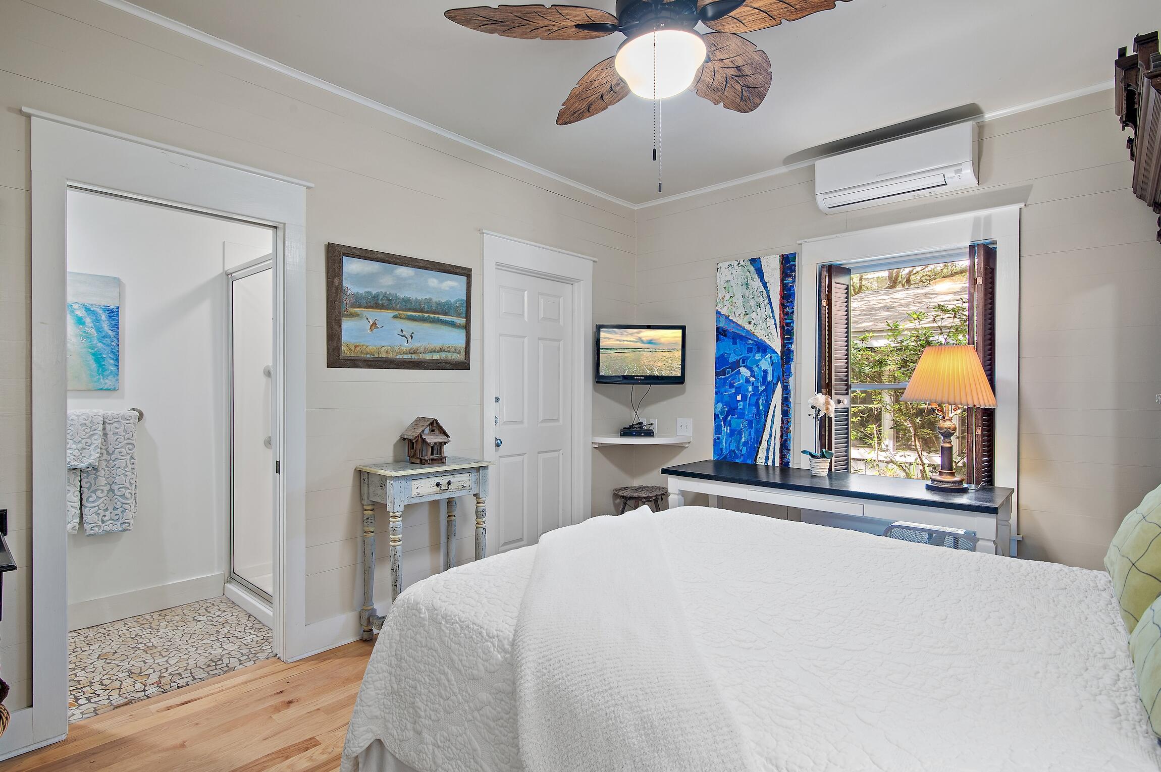 291 South Gulf Drive Santa Rosa Beach, FL 32459 - Photo 18 of 23 a bedroom with a bed and a chandelier