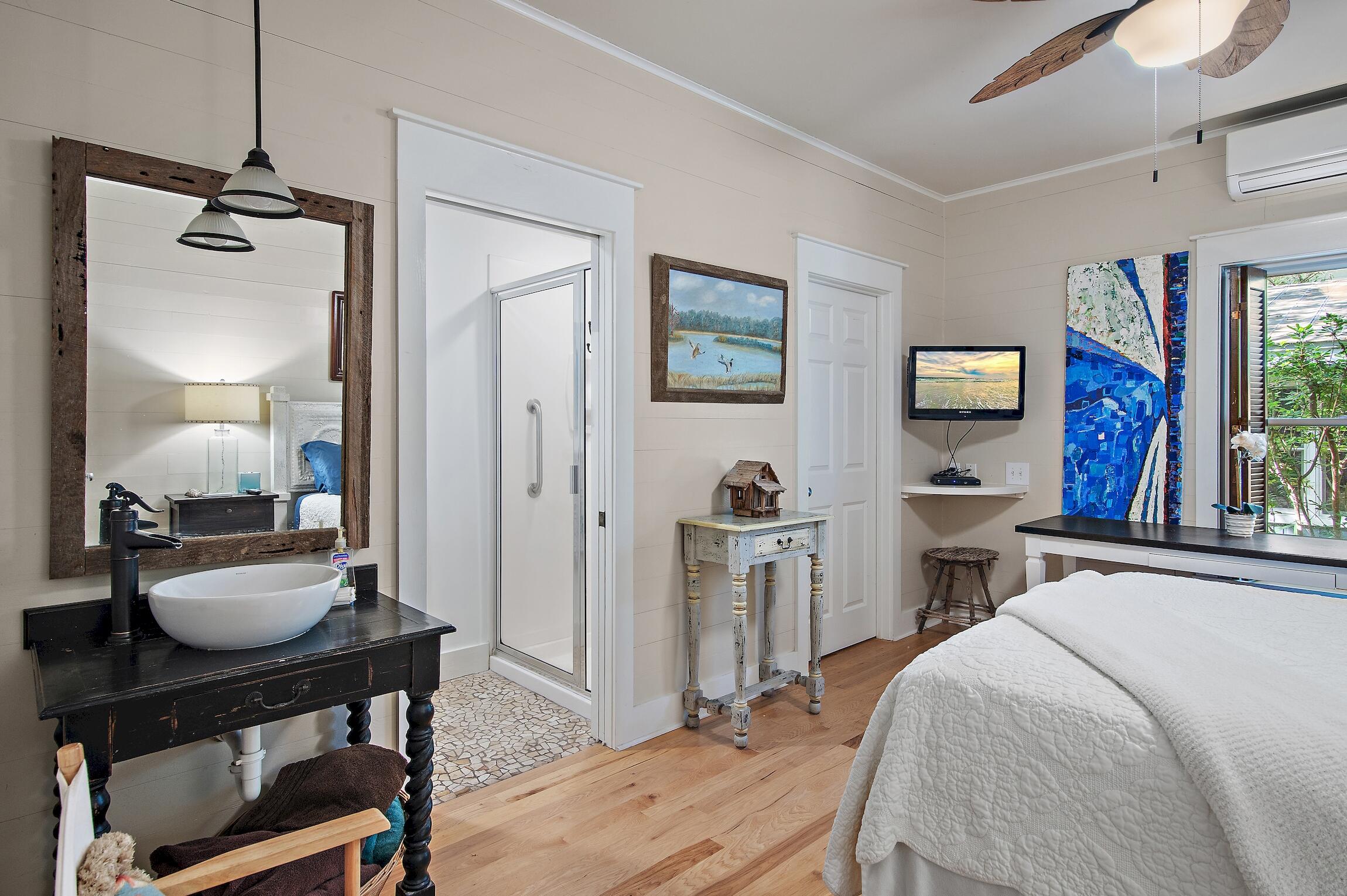 291 South Gulf Drive Santa Rosa Beach, FL 32459 - Photo 6 of 23 a bedroom with a bed a desk and chair