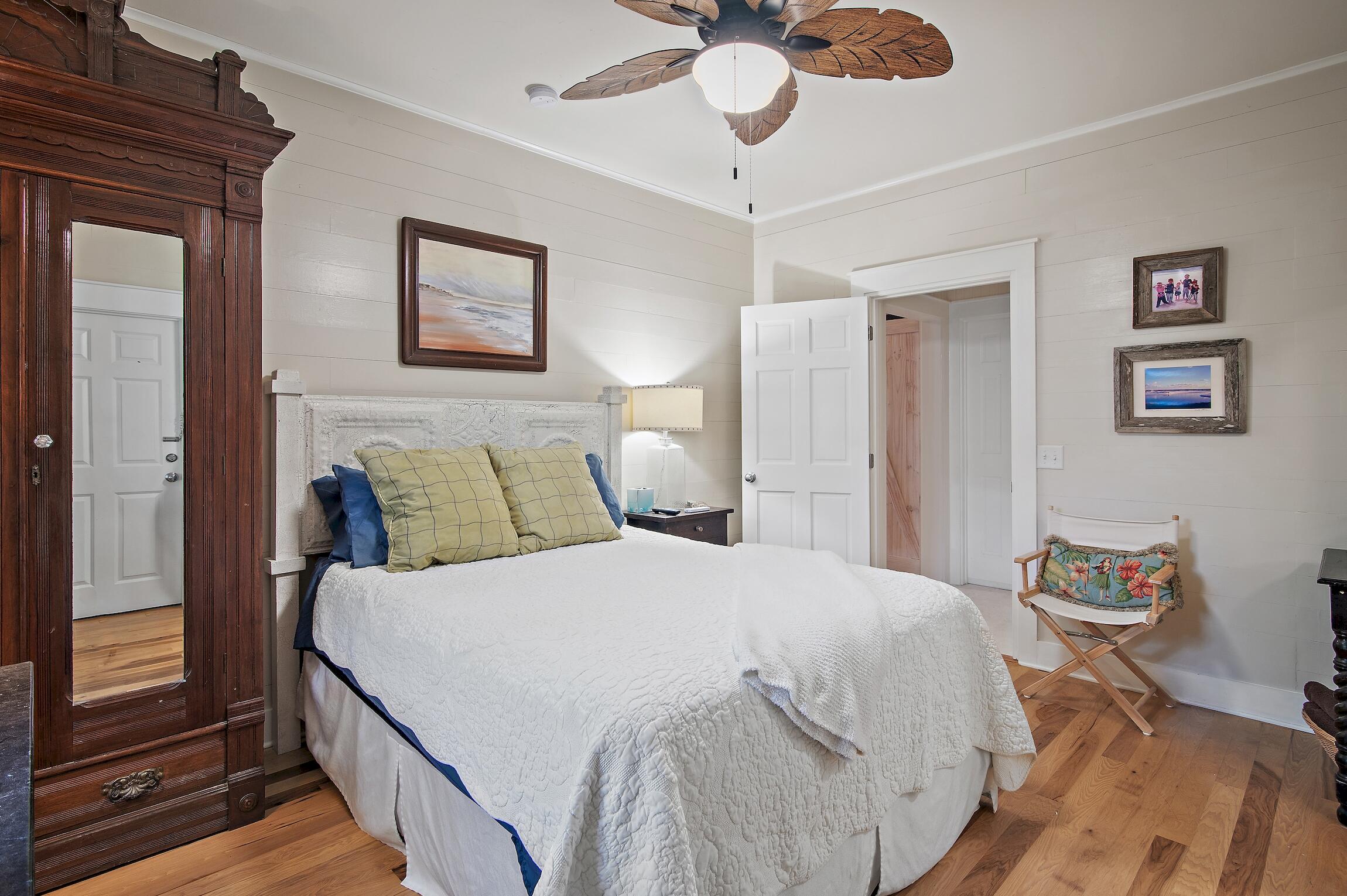 291 South Gulf Drive Santa Rosa Beach, FL 32459 - Photo 7 of 23 a bedroom with a bed and wooden floor