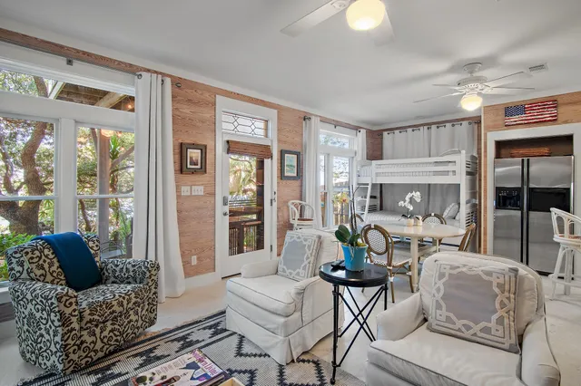 a living room with furniture and a floor to ceiling window