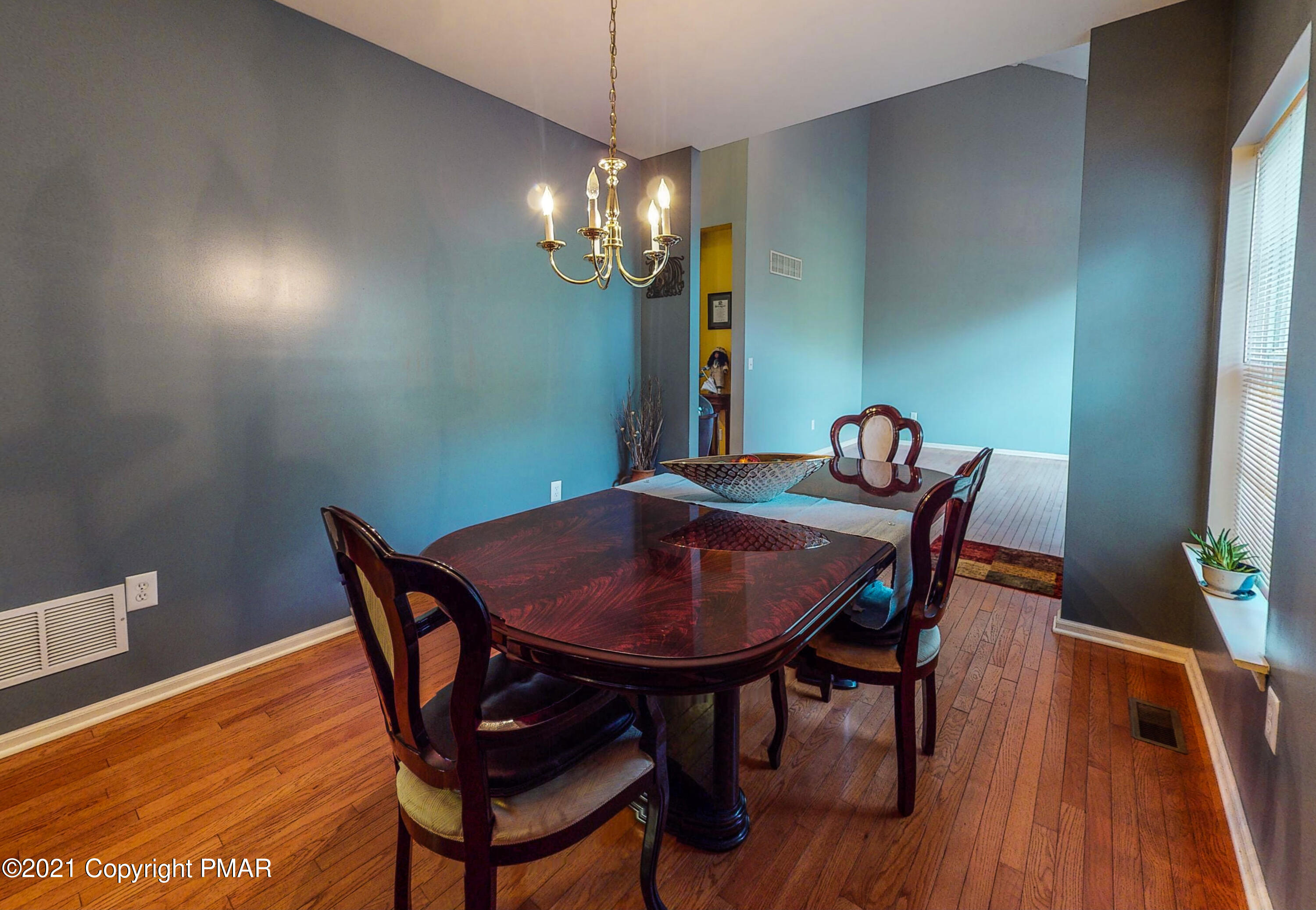 5631 Decker Road Bushkill, PA 18324 - Photo 15 of 61 a view of a dining room with furniture and wooden floor