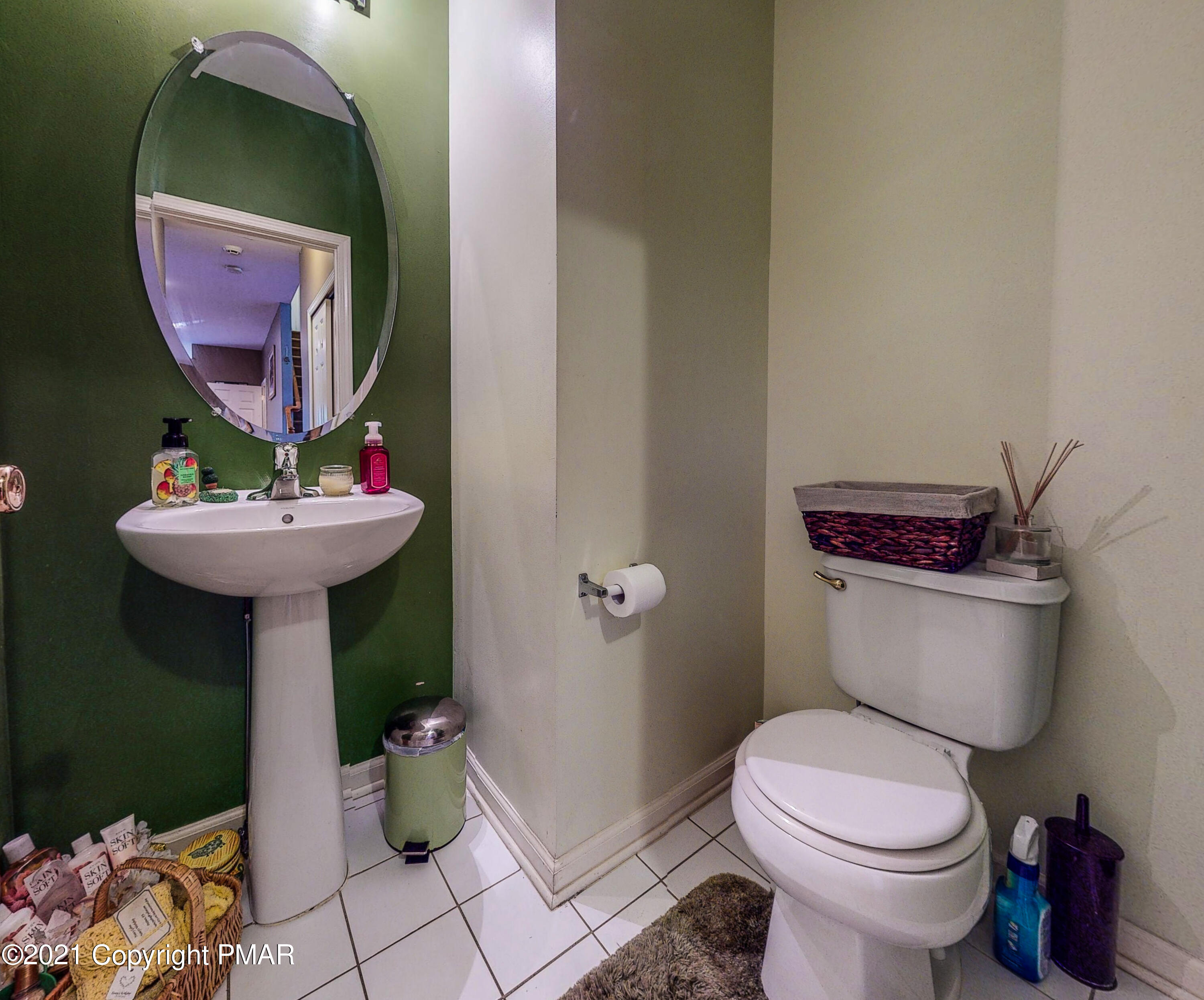 5631 Decker Road Bushkill, PA 18324 - Photo 24 of 61 a bathroom with a sink toilet and a mirror