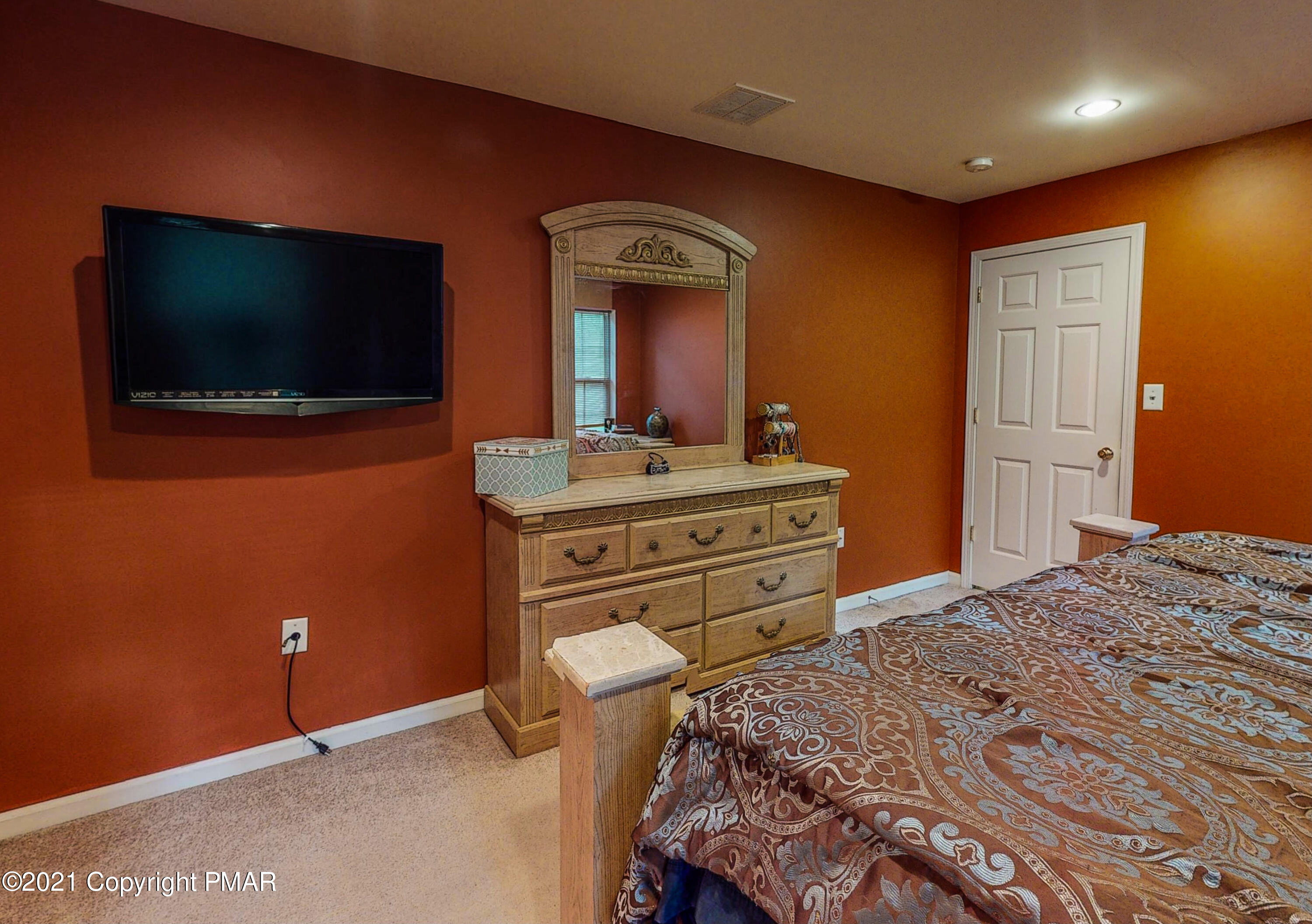 5631 Decker Road Bushkill, PA 18324 - Photo 27 of 61 a bedroom with a bed and a flat screen tv