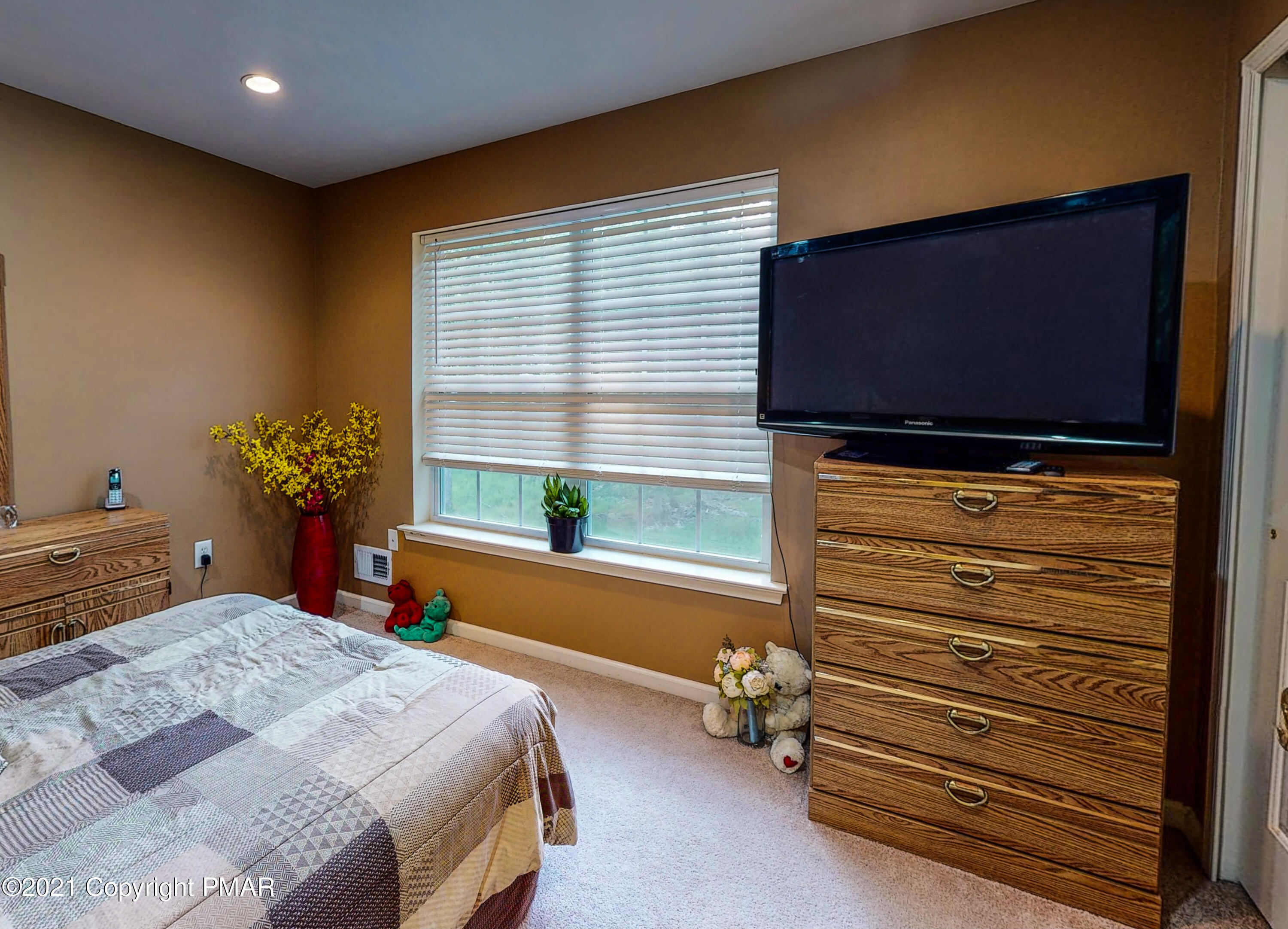 5631 Decker Road Bushkill, PA 18324 - Photo 32 of 61 a bedroom with a bed and a flat screen tv