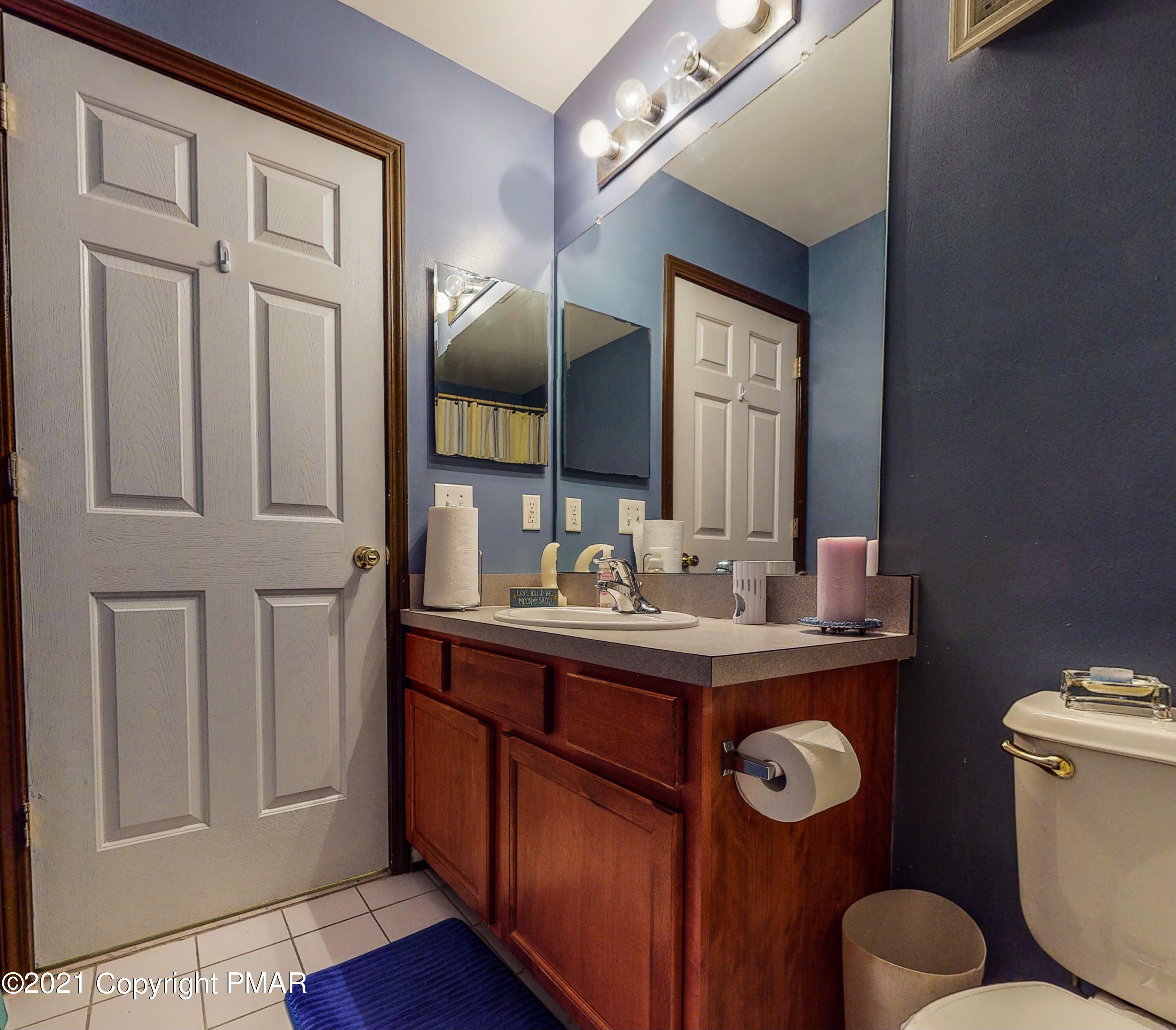5631 Decker Road Bushkill, PA 18324 - Photo 40 of 61 a bathroom with a toilet a sink and mirror