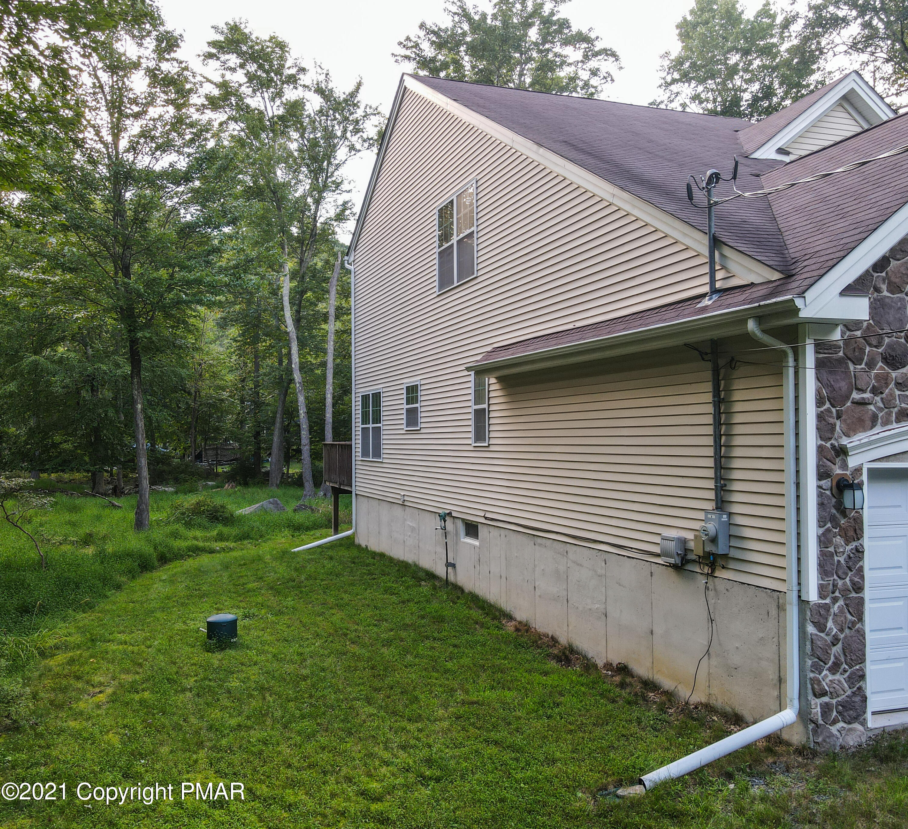 5631 Decker Road Bushkill, PA 18324 - Photo 48 of 61 a view of a backyard with plants and large trees