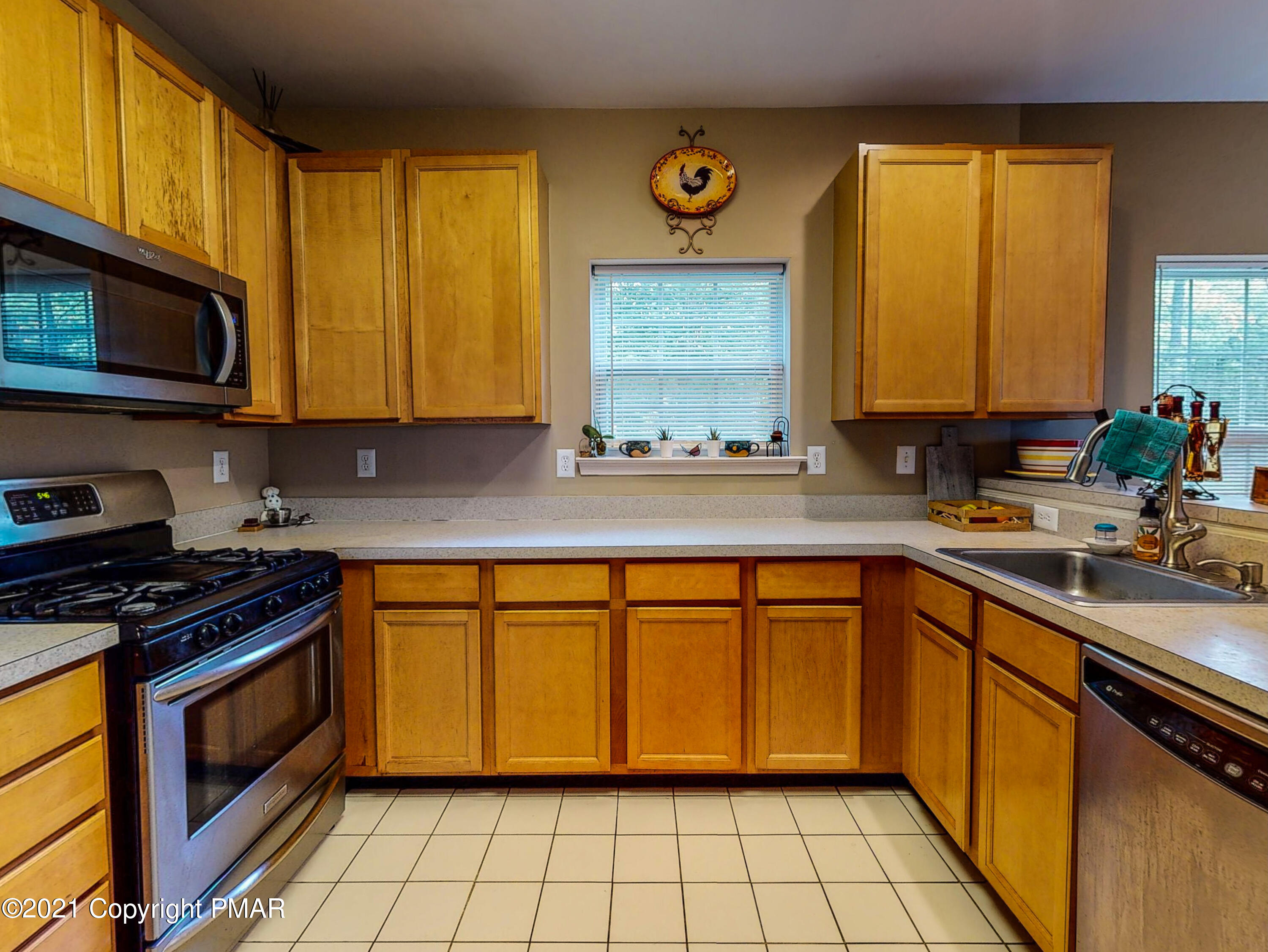 5631 Decker Road Bushkill, PA 18324 - Photo 6 of 61 a kitchen with stainless steel appliances a stove sink and microwave