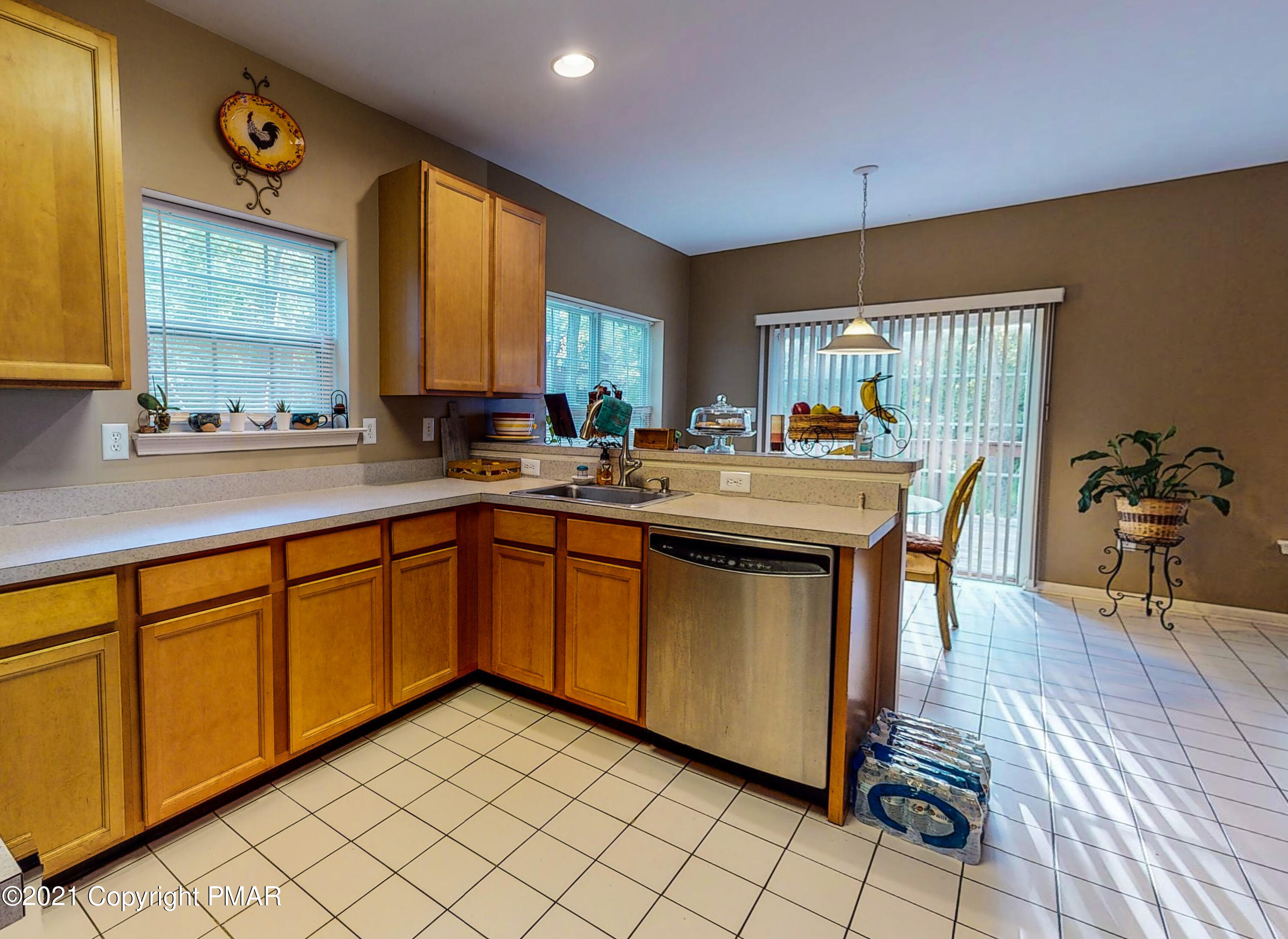 5631 Decker Road Bushkill, PA 18324 - Photo 7 of 61 a kitchen with stainless steel appliances granite countertop a sink a stove cabinets counter space and a window