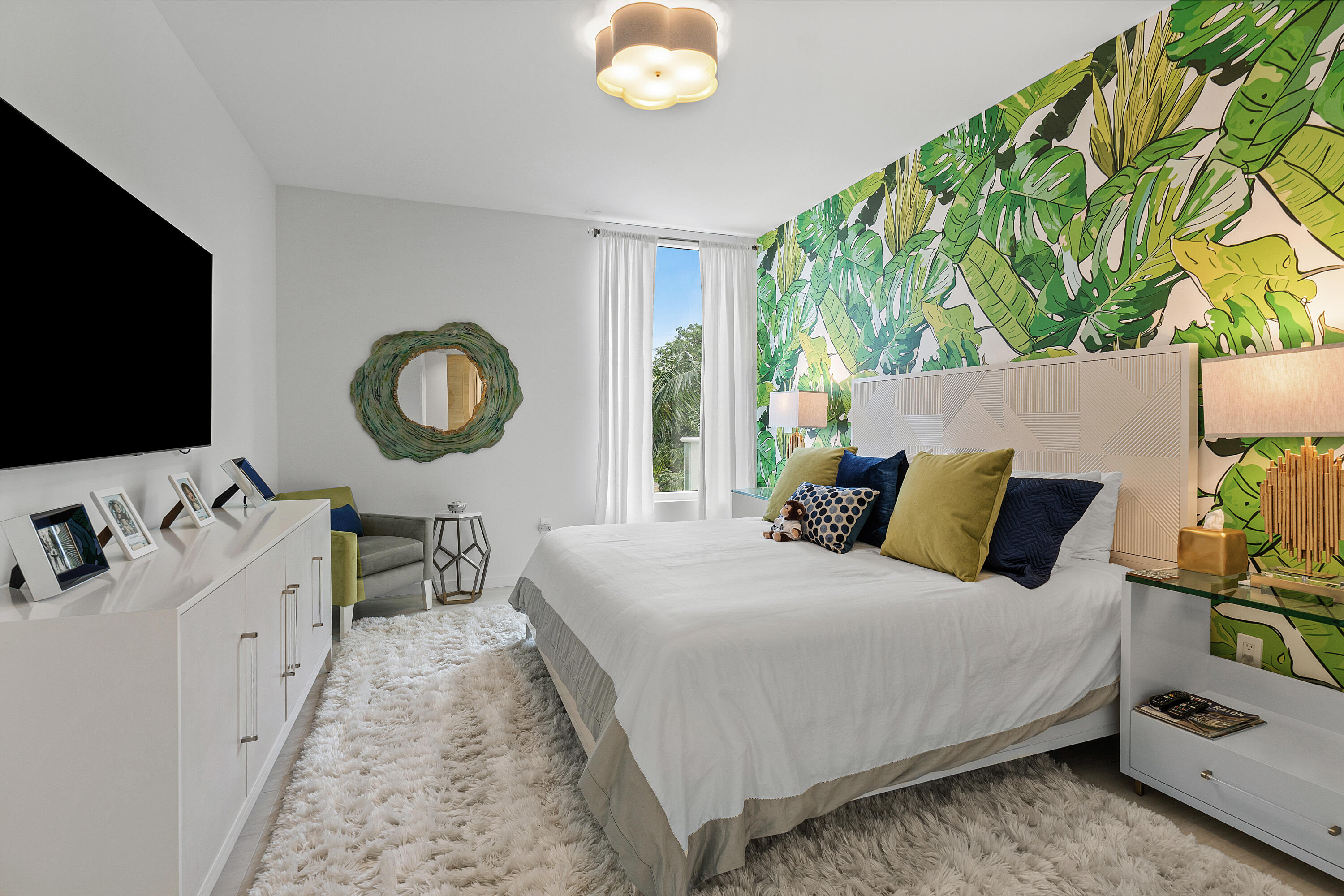 200 Southeast Mizner Boulevard, Unit 216 Boca Raton, FL 33432 - Photo 19 of 59 a bedroom with a bed and a flat tv screen on dresser