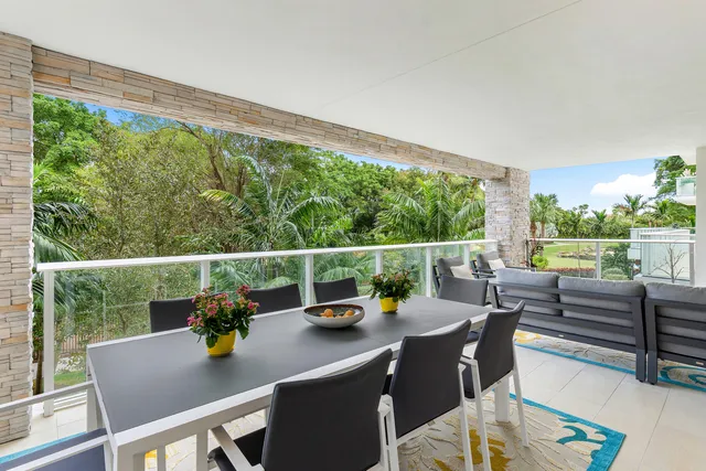 a large dining hall with stainless steel appliances a table and chairs