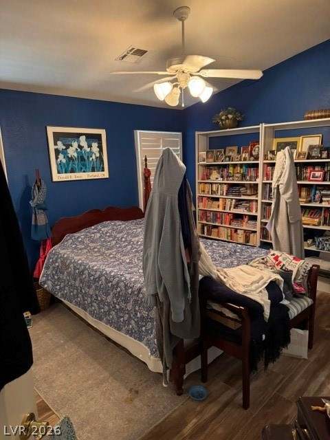 589 Beacon Ridge Way Mesquite, NV 89027 - Photo 12 of 18 Comfortable bedroom with built-in shelving, hardwood flooring, and a ceiling fan.