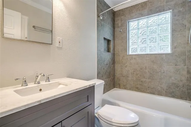 a bathroom with a sink a toilet and bathtub