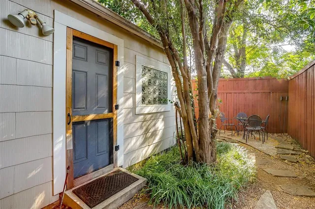 a backyard of a house with table and chairs
