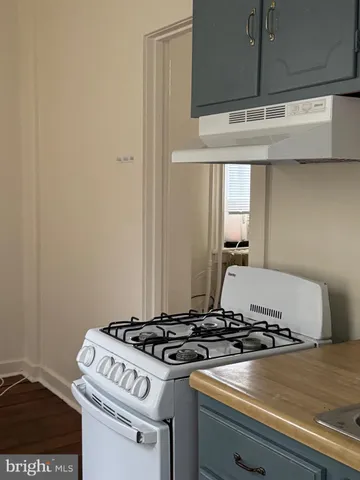 a stove top oven sitting inside of a kitchen