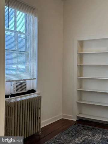a view of storage and utility room with wooden floor