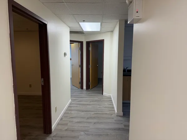 a view of a hallway with wooden floor