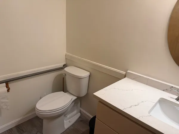 a white toilet sitting next to a white sink